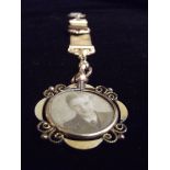 A very rare and unusual yellow metal photo pendant with mother of pearl swastika.