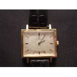 A 1965 Omega wrist watch with square face and leather strap, 2,7 cm wide.