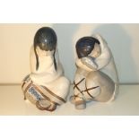 A pair of Lladro figures modelled as huddled Eskimos with one boy and girl. Impressed marks to