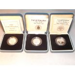 Three silver proof one pound coins, boxed with COA