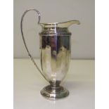Silver neoclassical cream jug, acanthus leaf capped handle, raised on a spreading foot,