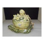 A covered tureen with floral design with snails and caterpillars in the majolica style. Signed by