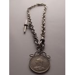 A silver Albert chain with "T" bar and a mounted 1887 coin. 49 grams