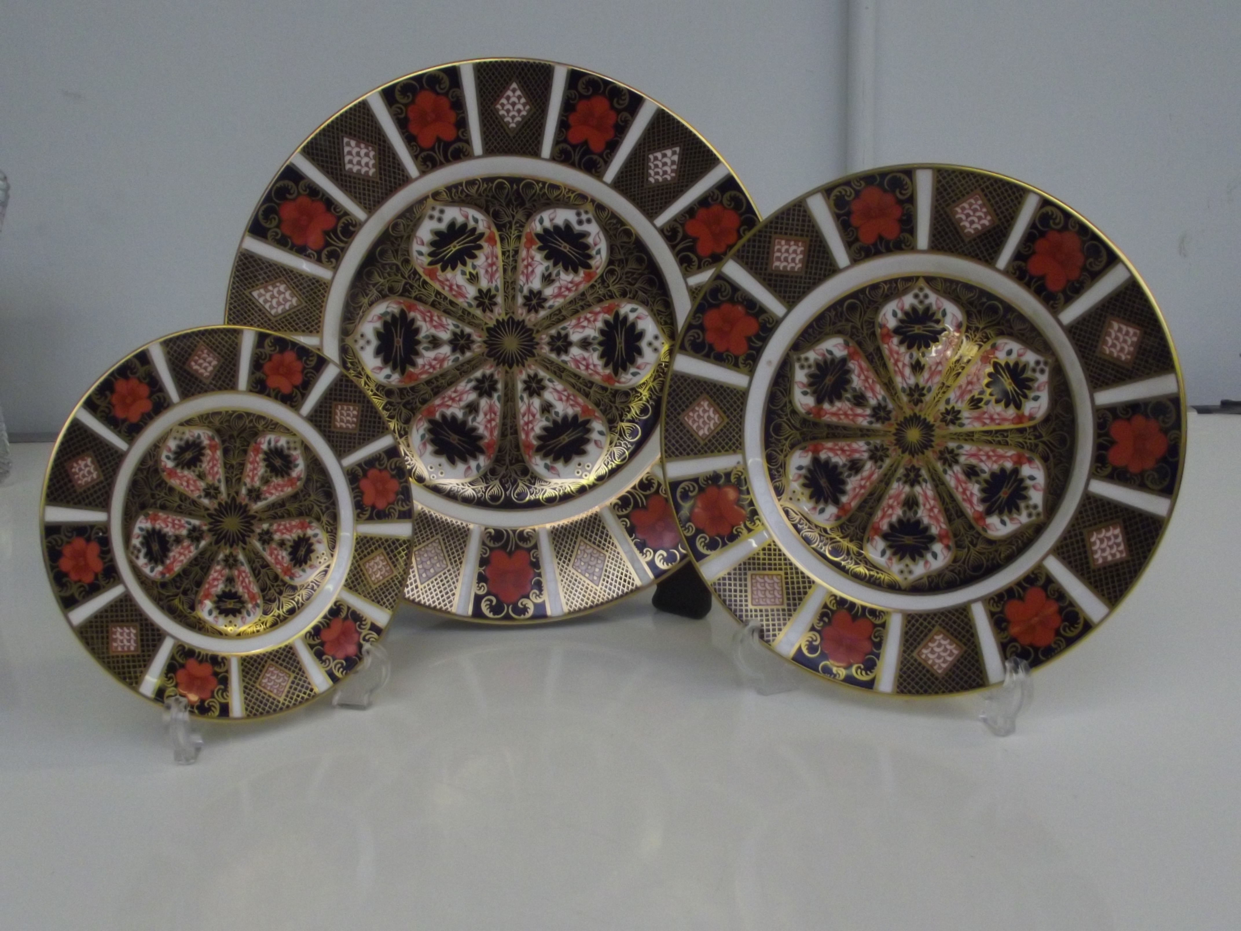 Three Royal Crown Derby Old Imari pattern plates 1128. Largest 27cm diameter