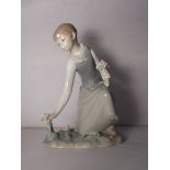 Lladro figure of a girl with flowers, 20cm in height