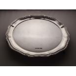 A silver salver with shaped edge, 8 inches diameter. Sheffield 1914. 302 grams