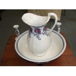 Losol ware wash basin and jug with two candlesticks and a vase.