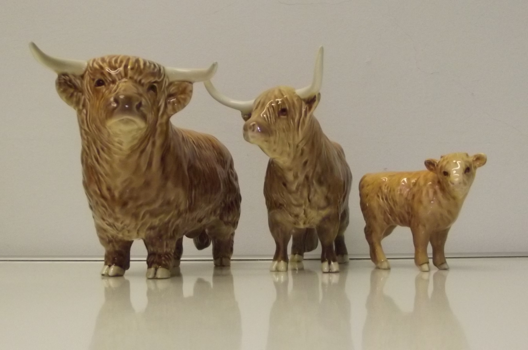 Beswick Highland trio comprising - Highland Bull, cow and calf. Height of Bull 13cm