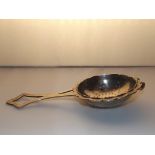 A silver tea strainer, London, maker SAH. 51 grams