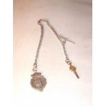 A silver Albert chain with "T"bar, fob and pocket watch key. Total weight 36 grams