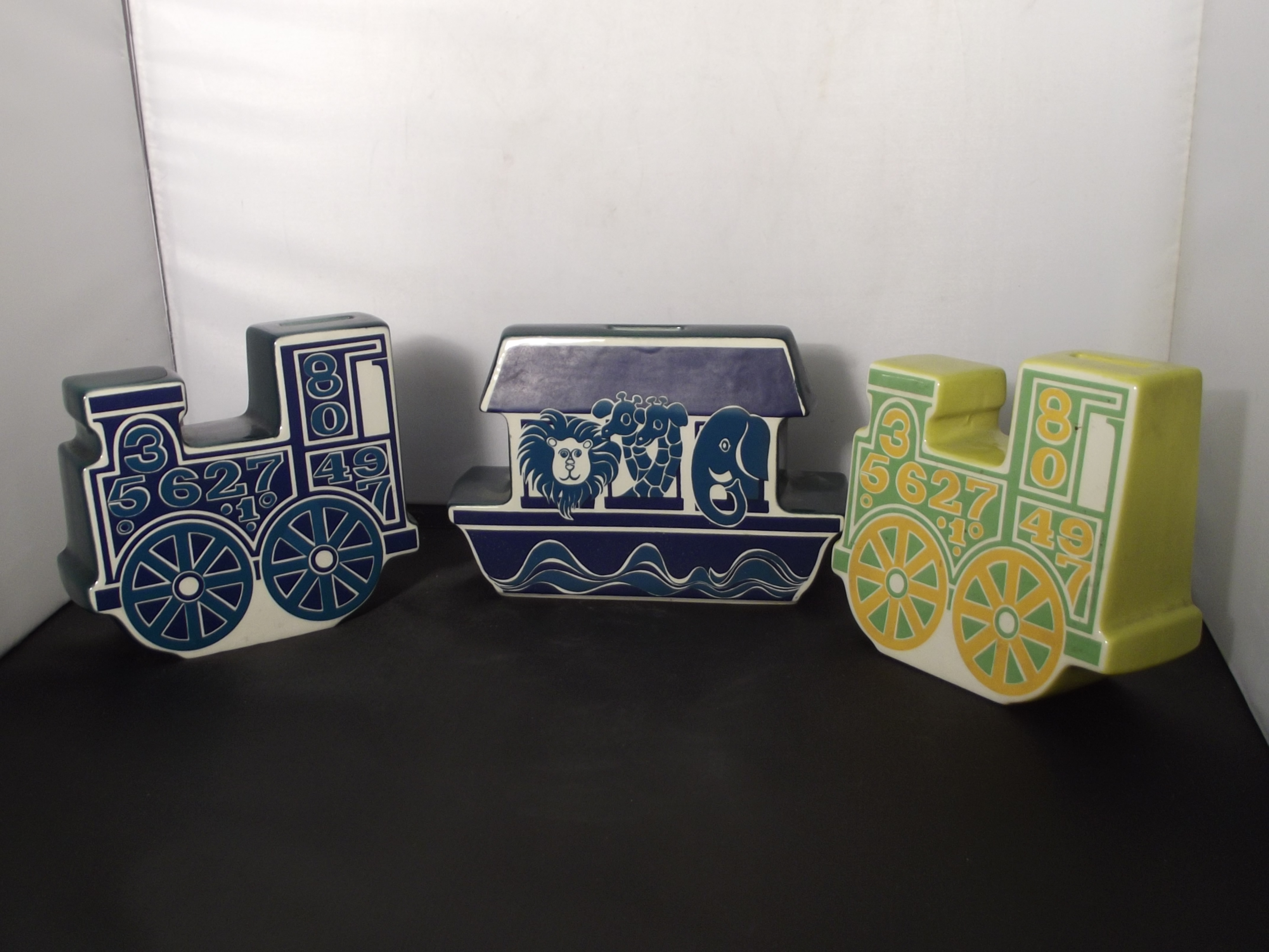 Group of three retro Carlton Ware money boxes, two in the form of trains, one in the form of Noah'