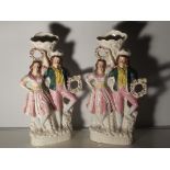 A pair of large Staffordshire flat backs of a couple holding flower reefs. 40cm high
