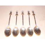 A part set of five silver prize spoons with applied crests to terminals, Birmingham 1927 - 1931