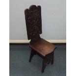 Solid oak spinning chair with deep carved back and front support, height 104cm, width 30cm
