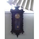 Vienna spring driven wall clock with grid iron pendulum and half turned poles to case, ivorine