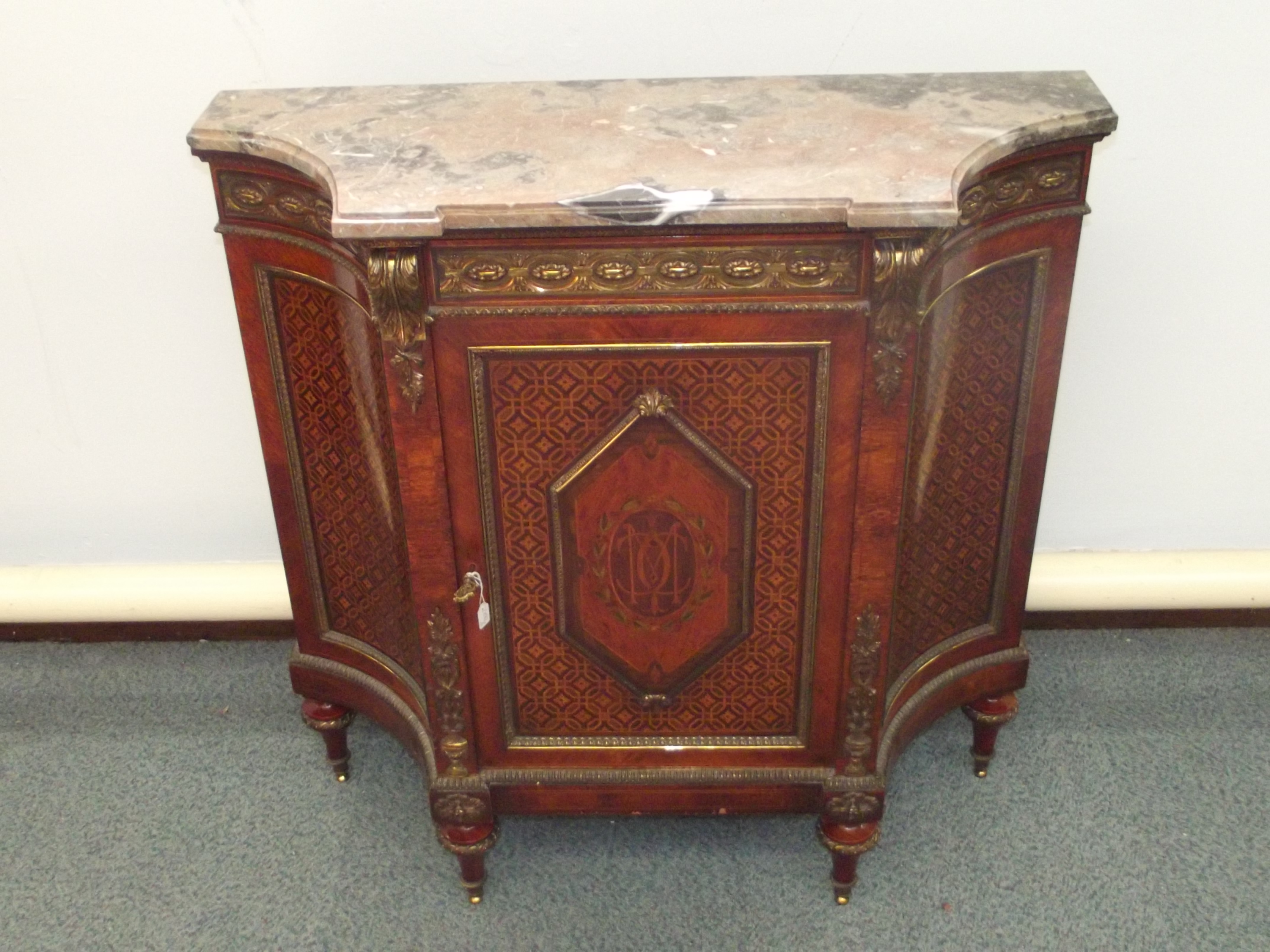 Italian marquetry side cabinet with marble top, convex side panels and mounted in ormalou with