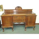 Solid mahogany sideboard in the Chippendale style carried on Queen Anne legs terminating to ball and