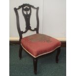 Edwardian carved lyre back nursing chair with overstuffed seat on cabriole style legs
