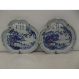 Pair of shallow Chinese dishes in the form of lily pads, depicting scenes of a lake with tea house