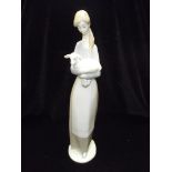 Lladro figure of a lady holding a lamp 26cm