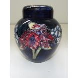 Moorcroft pottery lidded ginger jar tublined in the orchid pattern against a blue ground ,