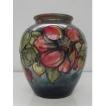 Moorcroft pottery vase , bulbous form , tube lined in the clematis pattern against a fading ground ,