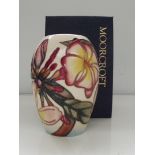 Moorcroft pottery vase ,oviod form, tube lined in the Frangipani pattern against an ivory ground ,