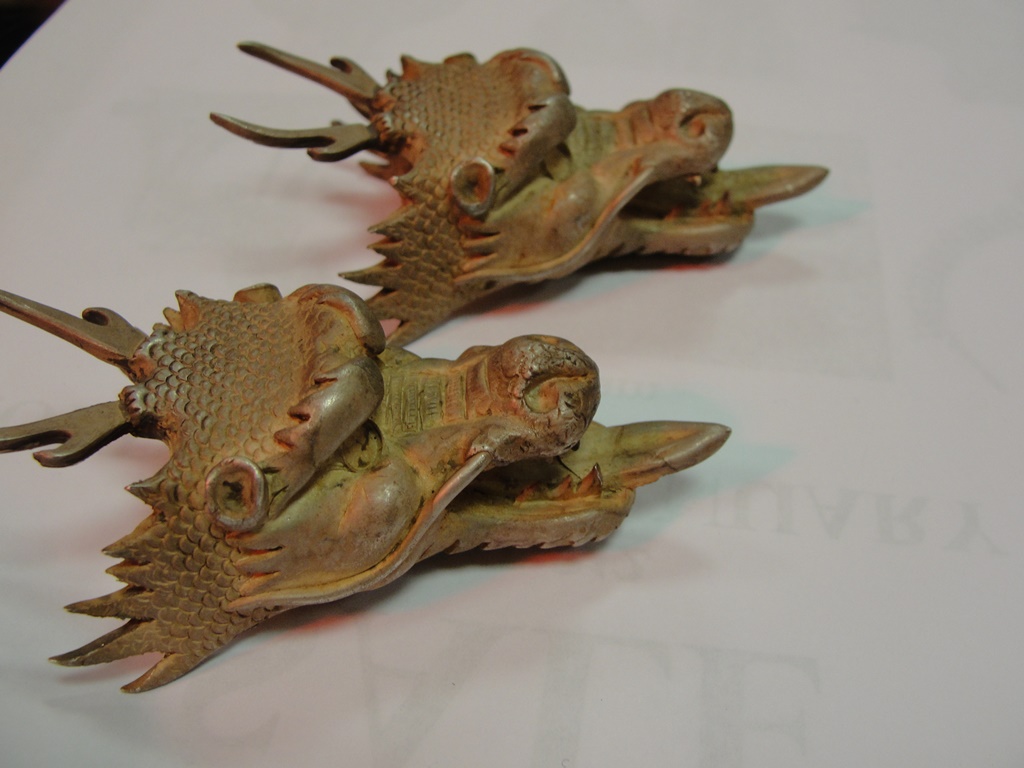 A pair of English silver dragons heads