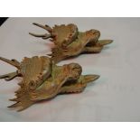 A pair of English silver dragons heads