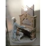 A Lladro figure of Mozart playing the or