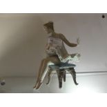 A Lladro figure: 'Ballerina sitting on a