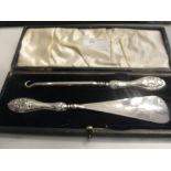 A cased HM silver-handled buttonhook and