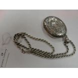 A large white metal locket and silver ch