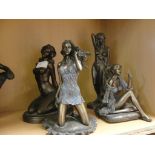 Four bronzed figures