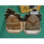 A pair of carved armorial wall brackets