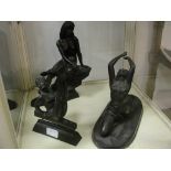 Three bronzed figures