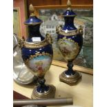 A pair of Edwardian urn vases with brass