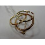 A 9ct three hoop tri-colour gold brooch