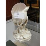 A Royal Worcester conch shell on coral