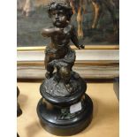 A bronze figure of a cherub