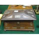 A sarcophagus-shaped rosewood tea caddy with mother-of-pearl inlay