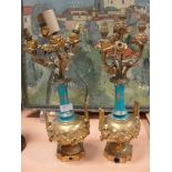 A pair of 19th century lamps with ormolu and ceramic fittings and rose finials