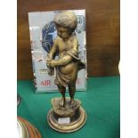 A brass putti figure