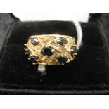 A sapphire, gold and diamond ring