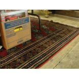 A red and blue patterned Persian rug