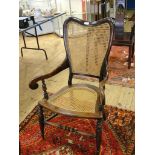 A 19th century cane and mahogany easy chair