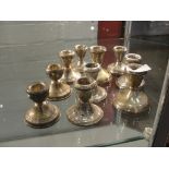 Five pairs of silver squat candlesticks