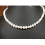 A 9ct clasped string of pearls