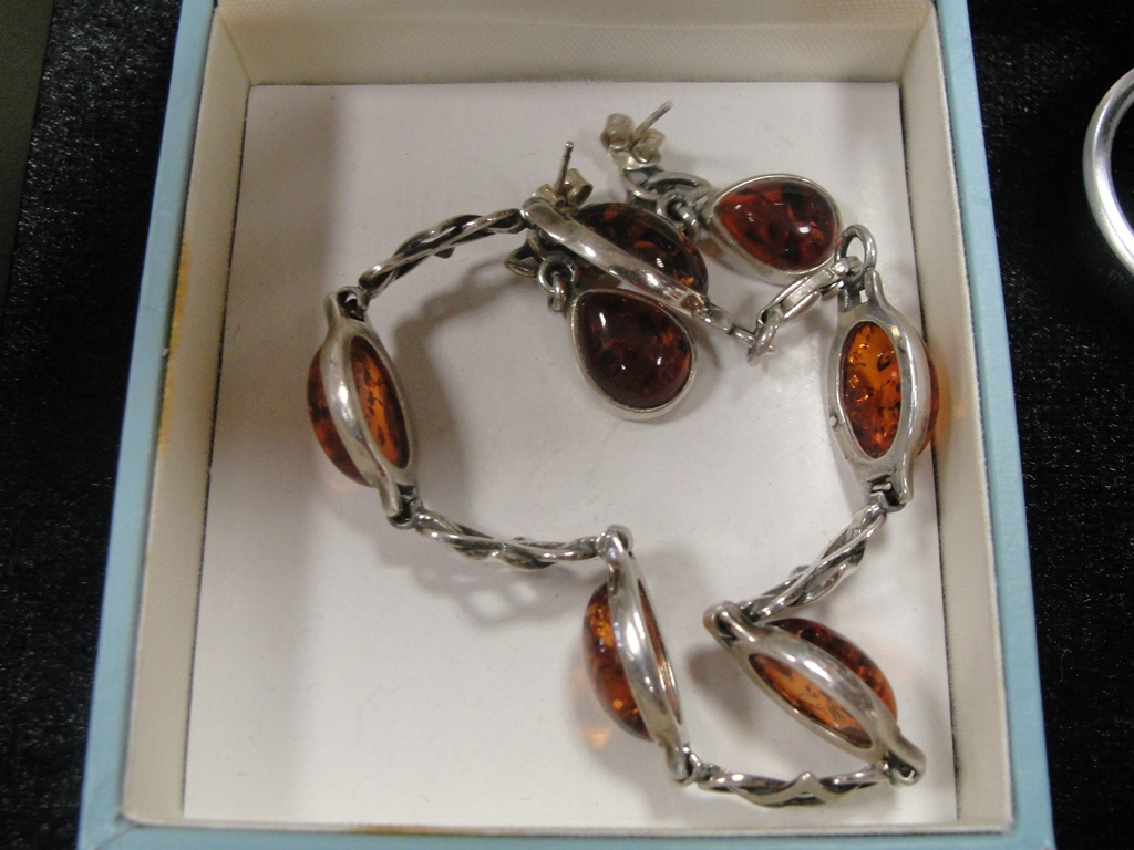 A pair of silver and amber earrings;