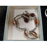 A pair of silver and amber earrings;